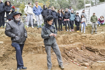 Paco Etxeberria y Lourdes Herrasti, junto a la fosa con los alumnos al fondo. 