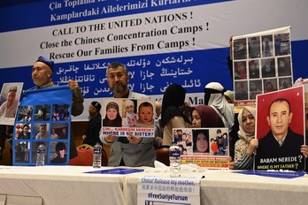Miembros de la comunidad musulmana uigur muestran fotografías de sus familiares detenidos en China durante una conferencia de prensa en Estambul, el pasado 10 de mayo.