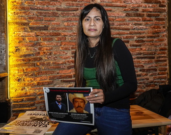 María de Lourdes Rosas Aguilar muestra un cartel con las fotos de los activistas desaparecidos Ricardo Arturo Lagunes y Antonio Díaz.