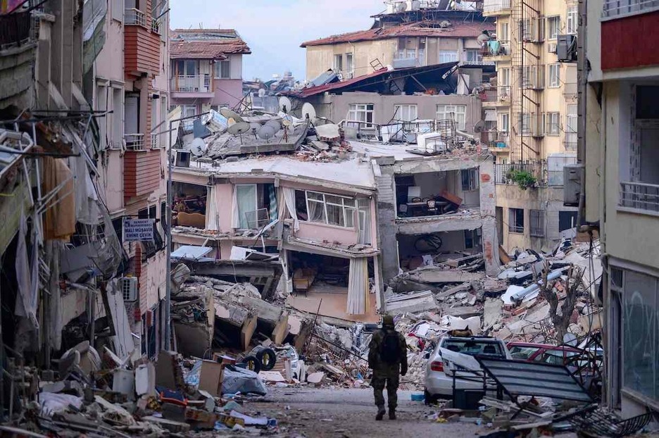 Un soldado turco camina entre edificios destruidos en Hatay.