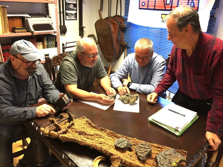 Miembros de Burdina Taldea, junto al arqueólogo Alfredo Moraza, muestran las escorias encontradas.