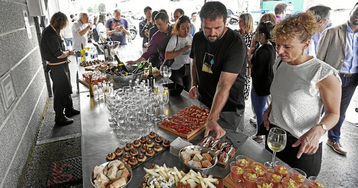 Bertatik gizarteratze eta laneratze enpresaren aurkezpen ekitaldiko irudia, mahai bete janarekin.