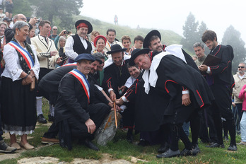 Los alcaldes de Erronkari y Baretous colocan sus manos sobre la Piedra de San Martín.