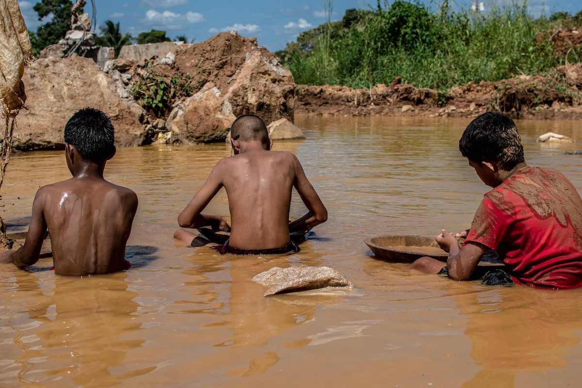 Tres niños trabajan en la extracción de oro en El Callao. (Magda GIBELLI/AFP)