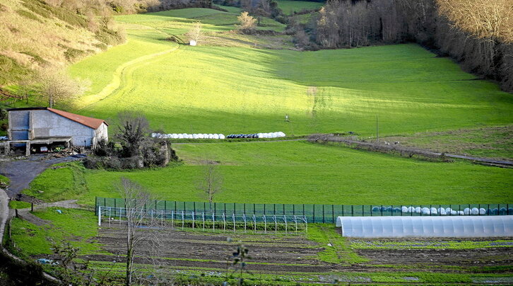 Iraetako Amillubi baserria, ezkerrean, bere zelai zabalez inguratuta.