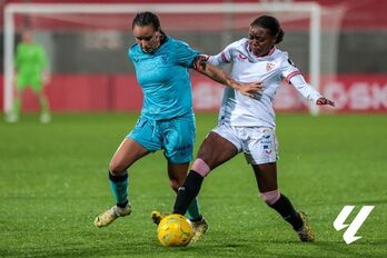 Nerea Nevado y Tony Payne pelean por el balón.
