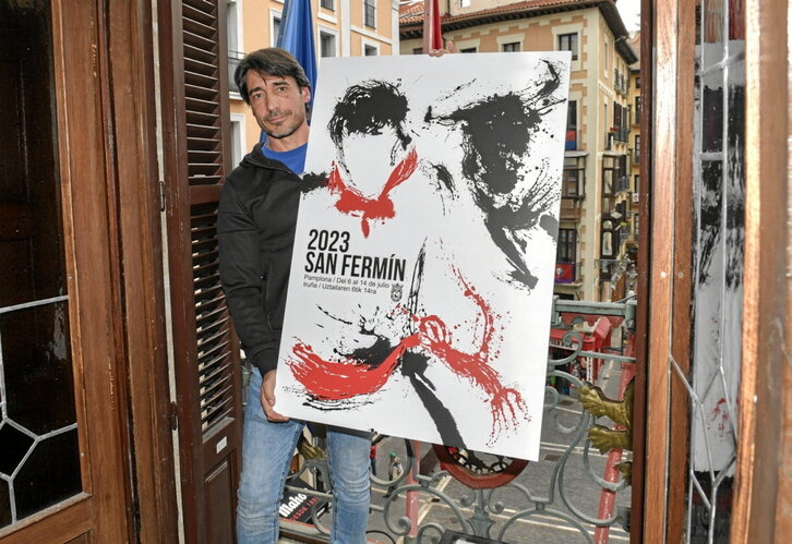 Raúl López posa junto a «Instante», el cartel anunciador de los Sanfermines de 2023.