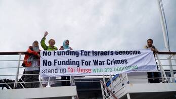 Parte de los integrantes de la Flotilla saludan desde el ferri Akdeniz, en el puerto de Tuzla, en Estambul.