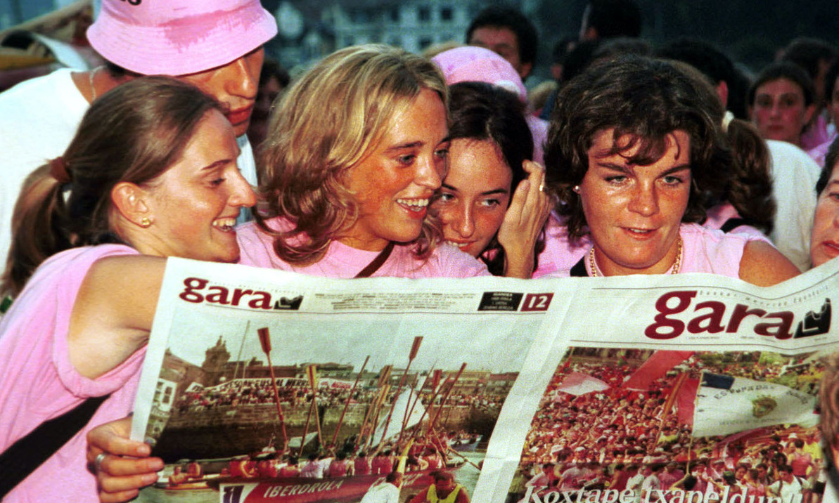 Unas jóvenes disfrutan del número especial de GARA publicado con motivo de las regatas de Donostia en 1999.