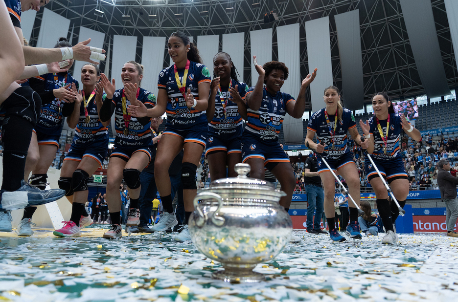 Kopa erdian eta jokalariak dantzan, Illunbeko kantxan. Kopa erdian eta jokalariak dantzan, Illunbeko kantxan.