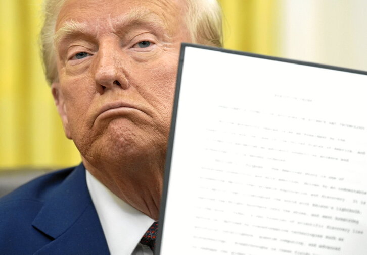 Donald Trump muestra en el Despacho Oval las órdenes ejecutivas que firmó el pasado día 23.