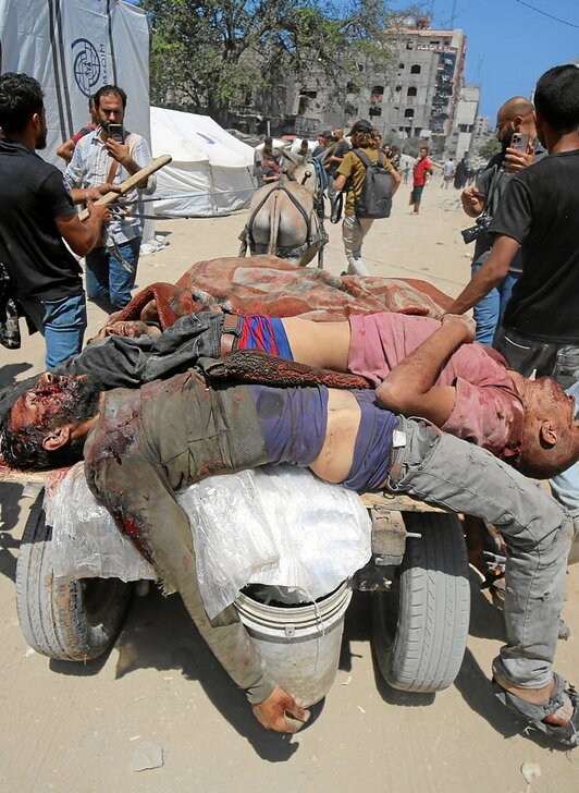 El padre de Yahya Fadi al-Najjar, un bebé de tres meses muerto por desnutrición, sostiene su cuerpo.