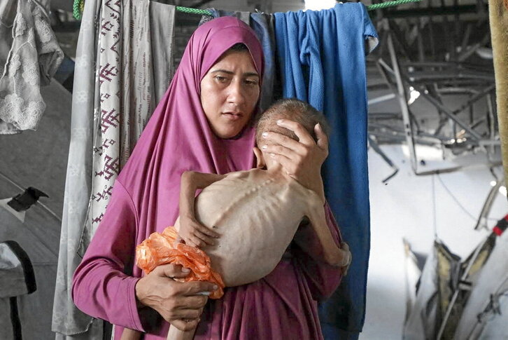 Una mujer lleva en brazos a un bebé palestino gravemente desnutrido el pasado día 4 en Gaza.