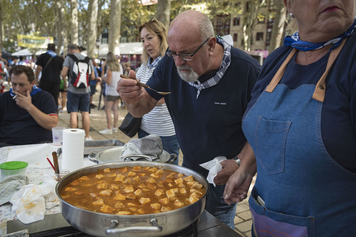 Uno de los participantes prueba el punto del marmitako que estaban guisando.