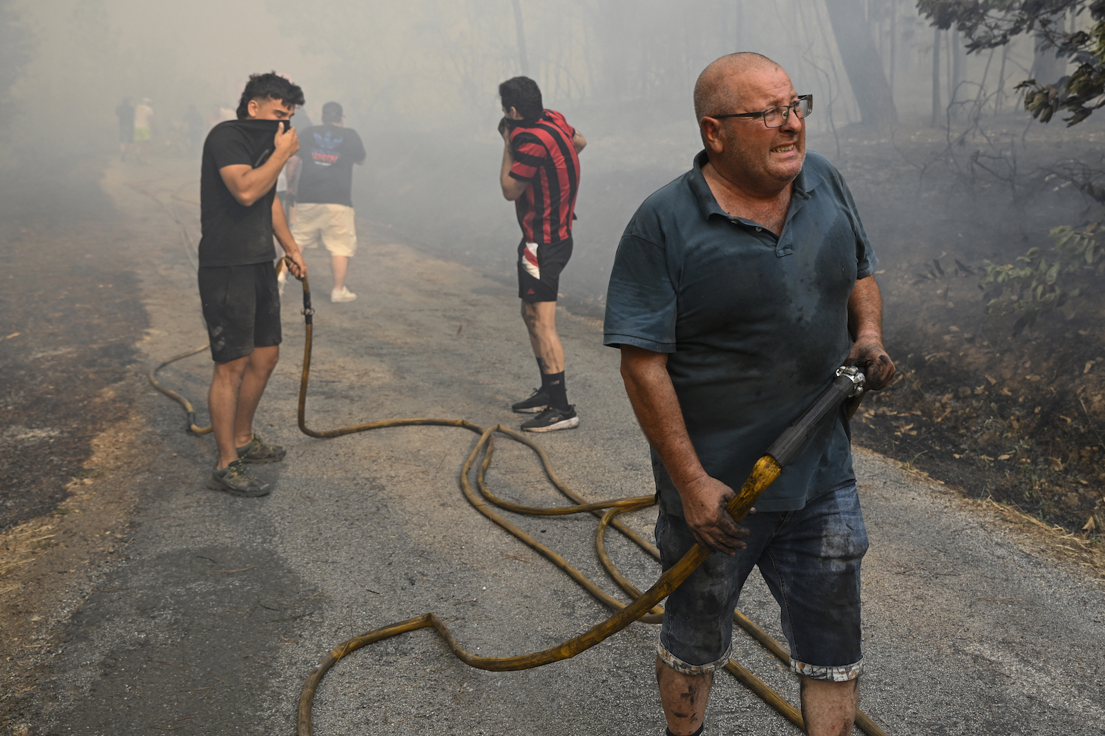 Vecinos trabajando en labores de extinción en Ourense. (Miguel RIOPA | AFP)