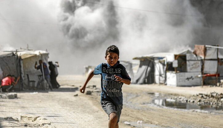 Un niño huye de la destrucción de una de las torres de viviendas que Israel está demoliendo en la Ciudad de Gaza.