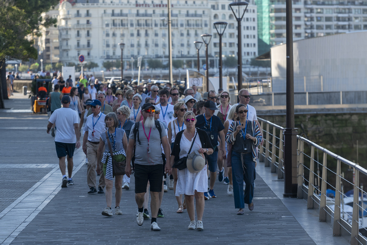 Un grupo de turistas pasea por el puerto de Donostia. 