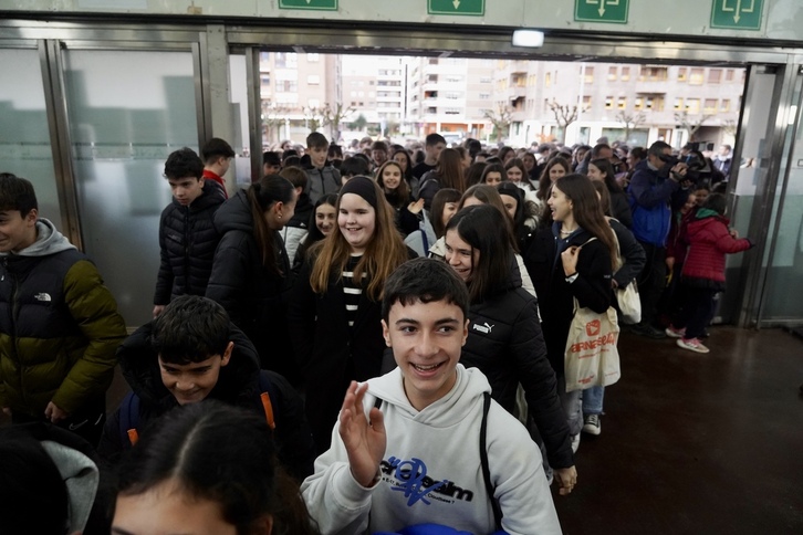 Haur eta gazteak pozik, Landako Guneko atea zeharkatzen.