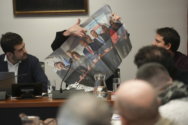 Santiago González muestra una foto de Benjamin Netanyahu con responsables de CAF-Israel, durante su comparecencia en el Parlamento navarro.