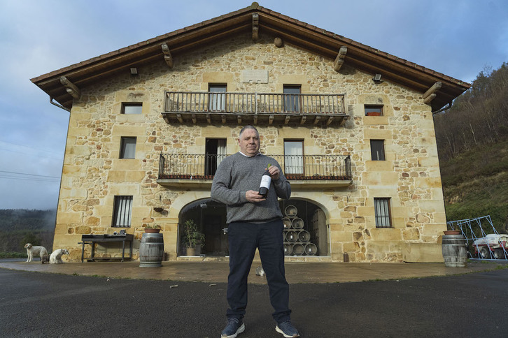 Joxe Lapazaran, XIX. mendeko baserrian duen upategiaren aurrean.