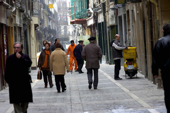 Pertsona batzuk Alde Zaharretik paseatzen, artxiboko irudian.