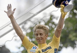 Greg Lemond Pariseko podiumean, 1986ko Tourraren garaipena ospatzen. Beste bi edizio irabazi zituen, Miguel Induraini lekukoa eman aurretik.