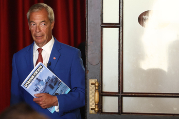 El líder de Reform UK, Nigel Farage, llega para asistir a una rueda de prensa en un hotel del centro de Londres el 3 de agosto de 2026. Bajo el brazo porta un libro donde se puede leer: «Operación Fortress, parando la invasión de Gran Bretaña»