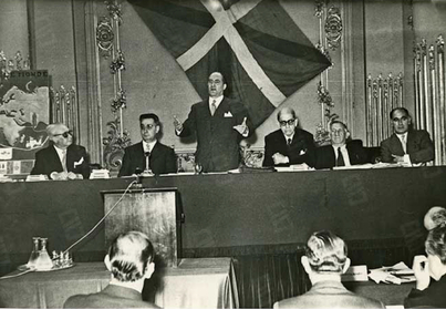 Imagen del Gobierno de Agirre presidiendo en París el I Congreso Mundial Vasco, con el lehendakari en pie, en plena intervención.